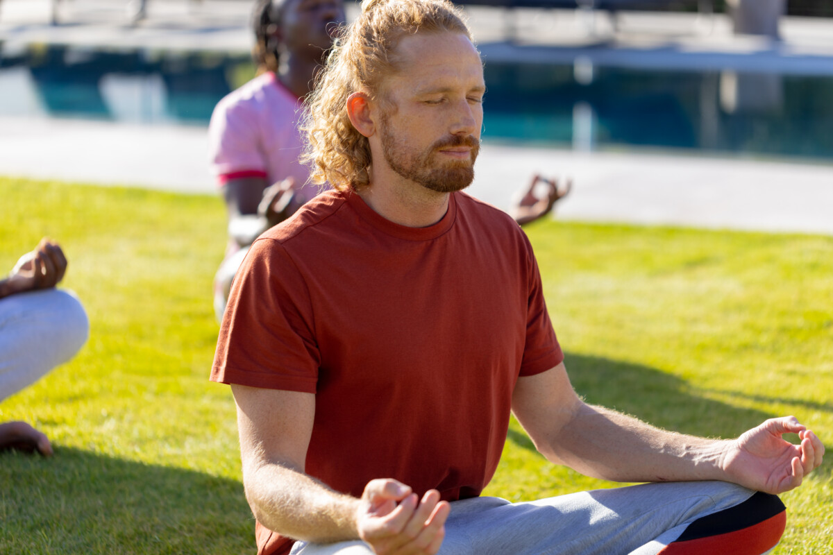 Man meditating outdoors representing mindfulness and transforming the subconscious for lasting change