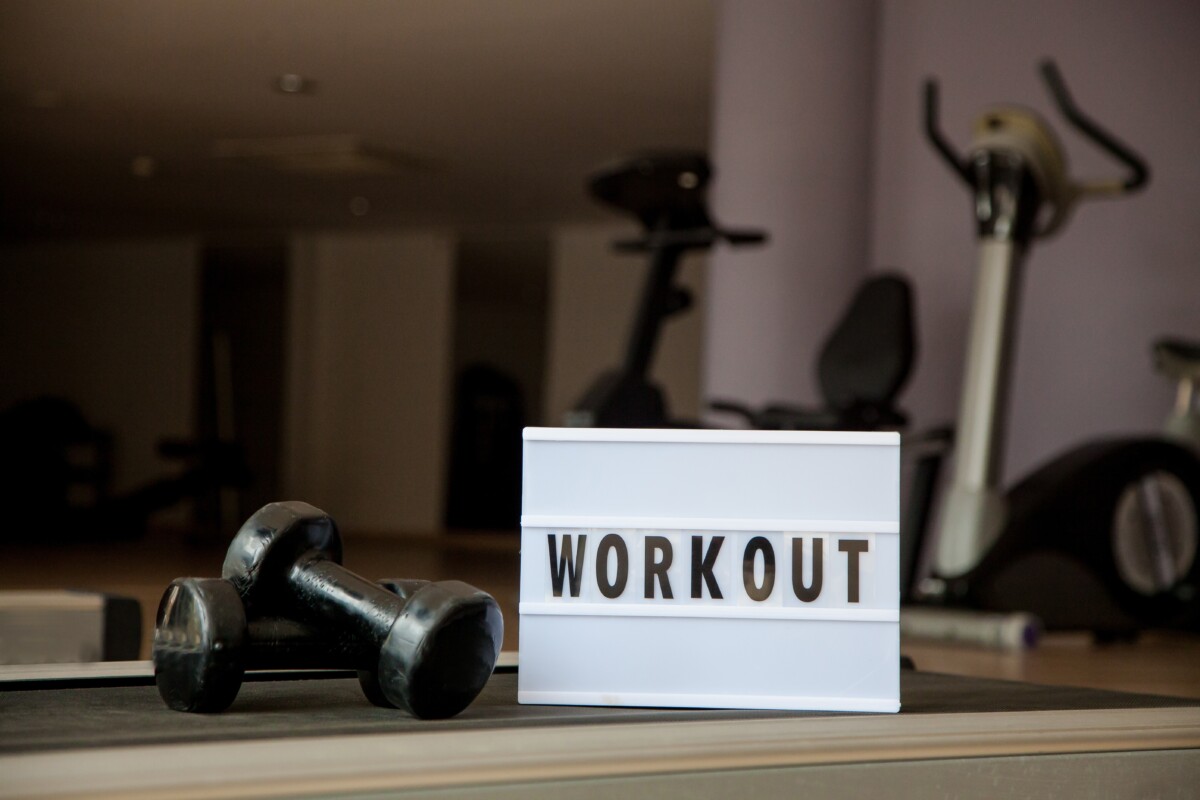 Workout sign at the gym reminding members to stay consistent when working out but not seeing results.