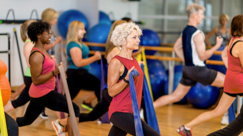 woman over 40 strength training with bands to improve health and longevity, Strength Training After 40 for a Longer, Healthier Life