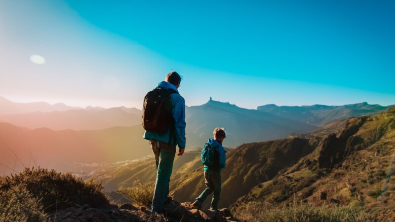 Lifestyle performance training father hiking outdoors with son representing real fitness success and healthy living Lifestyle performance training father hiking outdoors with son representing real fitness success and healthy living